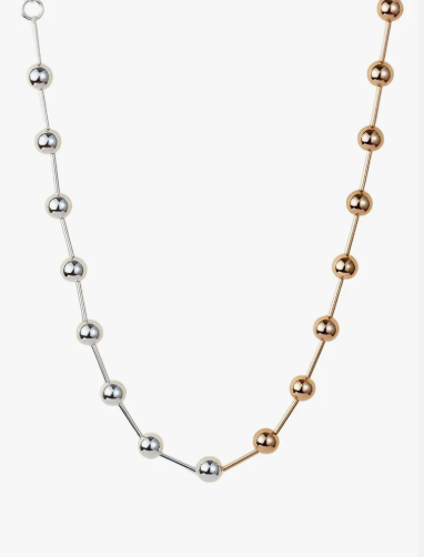 Gold and silver bracelets stacked together, mixed metal jewelry trend